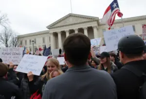 Protests with signs against National Guard deployment and ICE facility conditions.