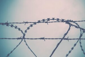 Close-up of barbed wire on a security fence